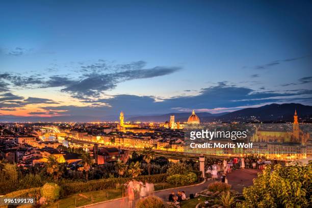 lookout platform at piazzale michelangelo, illuminated city panorama at dusk with florence cathedral, cathedral of santa maria del fiore, palazzo vecchio, ponte vecchio, unesco world heritage site, florence, tuscany, italy - fiore stock pictures, royalty-free photos & images