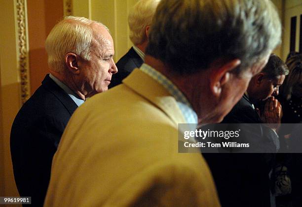 Sen. John McCain, R-Ariz., attends a briefing with the press after the senate luncheons. Sens. Kit Bond, R-Mo., center, and Lindsey Graham, R-S.C.,...