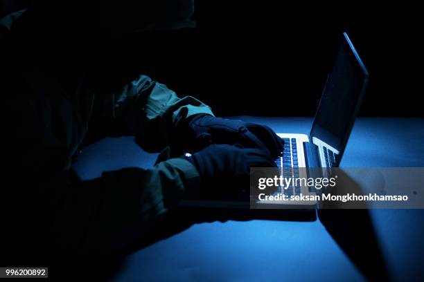 payments system hacking. online credit cards payment security concept. hacker in black gloves hacking the system. - computer attack stock pictures, royalty-free photos & images