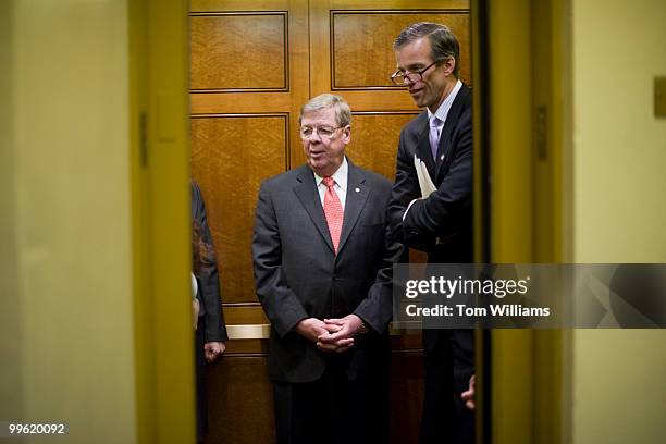 Sens. Johnny Isakson, R-Ga., left, and John Thune, R-S.D., ride an elevator to the senate luncheons, March 16, 2010.