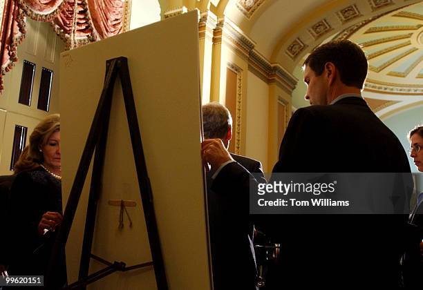 Sens. Bill Frist, R-Tenn., and Kay Bailey Hutchison, R-Texas, attend to a chart after the Senate Luncheons, Tuesday. The chart compared the...