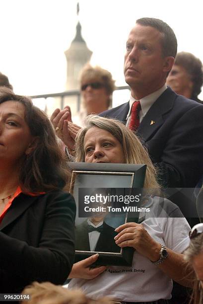 At rally in Upper Senate Park, MADD member Norma Tabish of Salt lake City, holds a picture of her son J.J., who was killed in a drunk driving...