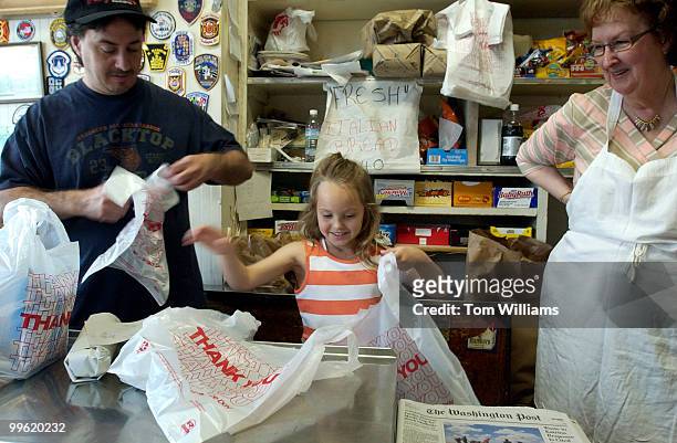 Josie Mangialardo helps her father Alex bag hoagies as her grandmother Lucille looks on at Mangialardo & Sons, Inc., on Pennsylvania Ave., SE. Josie...