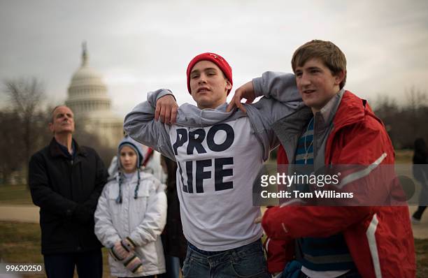 Spectator brandishes his tee shirt at the annual, anti-abortion, March for Life as the participants make their way on Constitution Avenue en route to...