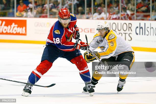 David Savard of the Moncton Wildcats skates with the puck while being defended by Brent Raedeke of the Brandon Wheat Kings during the 2010 Mastercard...