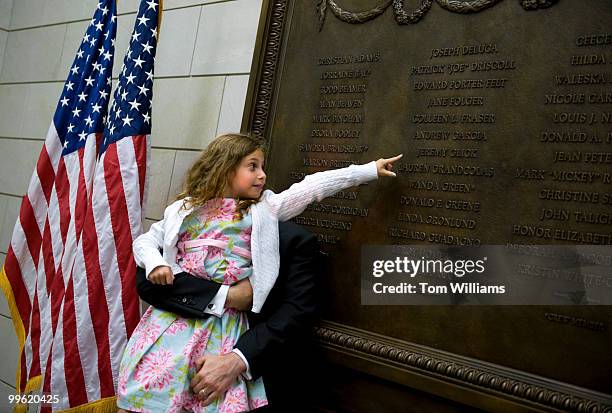 Emmy Glick points to her father's name, Jeremy Glick, on a plaque honoring United Flight 93 passengers, September 9 who died on September 11 when...