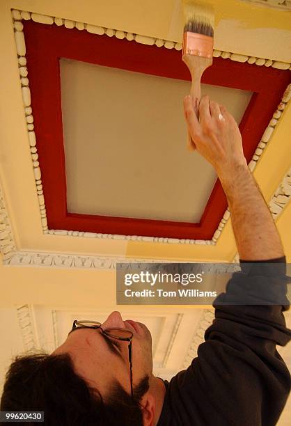 Jim Lorey of Evergreen Painting Studios, paints the Rotunda of Cannon building, which he and two other members of his crew will try to restore to...