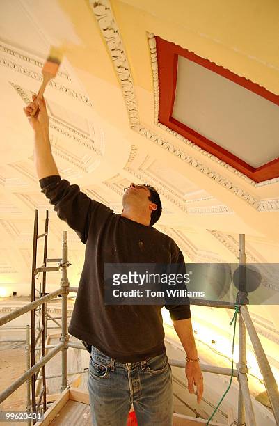 Jim Lorey of Evergreen Painting Studios, paints the Rotunda of Cannon building, which he and two other members of his crew will try to restore to...