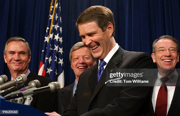 Sens. Bill Frist, R-Tenn., center, makes a joke about Sen. Max Baucus's, D-Mont, black eye at a news conference to discuss the passage of the...