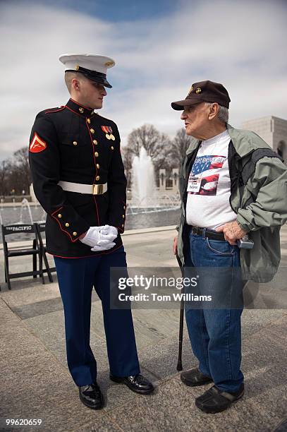 Marine veteran Frank DeZenzo talks with Lance Cpl. Kevin Hurst, after a tribute to honor WW II vets that served in the Pacific Theater, March 11,...