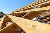wooden rafters on the roof of the house under construction