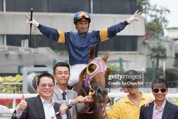 Jockey Gerald Mosse, trainer Benno Yung Tin-pang and owner celebrate after Winnam winning Race 8 Big Profit Handicap at Sha Tin racecourse during...