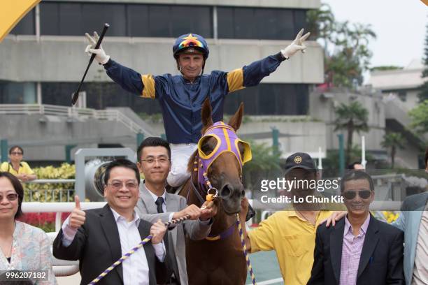 Jockey Gerald Mosse, trainer Benno Yung Tin-pang and owner celebrate after Winnam winning Race 8 Big Profit Handicap at Sha Tin racecourse during...