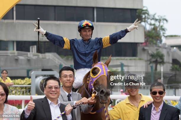 Jockey Gerald Mosse, trainer Benno Yung Tin-pang and owner celebrate after Winnam winning Race 8 Big Profit Handicap at Sha Tin racecourse during...