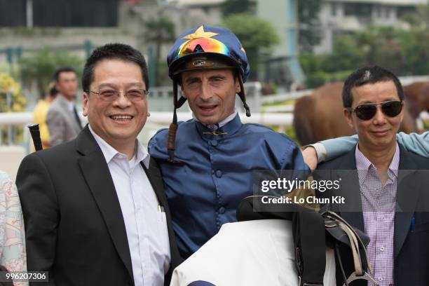 Jockey Gerald Mosse, trainer Benno Yung Tin-pang and owner celebrate after Winnam winning Race 8 Big Profit Handicap at Sha Tin racecourse during...