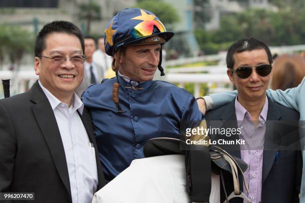 Jockey Gerald Mosse, trainer Benno Yung Tin-pang and owner celebrate after Winnam winning Race 8 Big Profit Handicap at Sha Tin racecourse during...