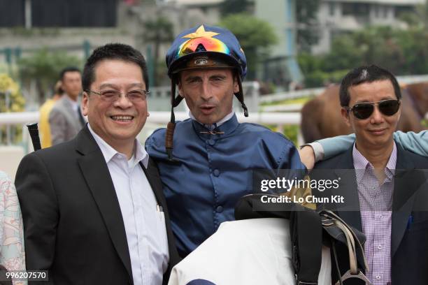 Jockey Gerald Mosse, trainer Benno Yung Tin-pang and owner celebrate after Winnam winning Race 8 Big Profit Handicap at Sha Tin racecourse during...