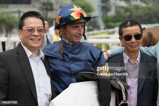 Jockey Gerald Mosse, trainer Benno Yung Tin-pang and owner celebrate after Winnam winning Race 8 Big Profit Handicap at Sha Tin racecourse during...