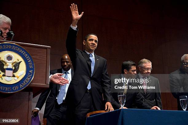 President Barack Obama arrives to address a House Democratic caucus meeting at the Capitol Visitor Center, March 20, 2010. Also appearing are, from...
