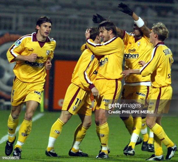 Metz's player Jonathan Jager is congratulated by his teammates after scoring a goal during their French L1 soccer match, 05 December 2003 at the...