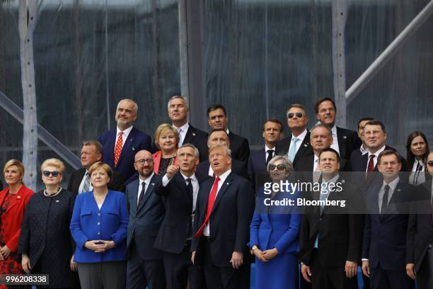 Jens Stoltenberg, secretary general of the North Atlantic Treaty Organization , center left, stands beside U.S. President Donald Trump, center right,...