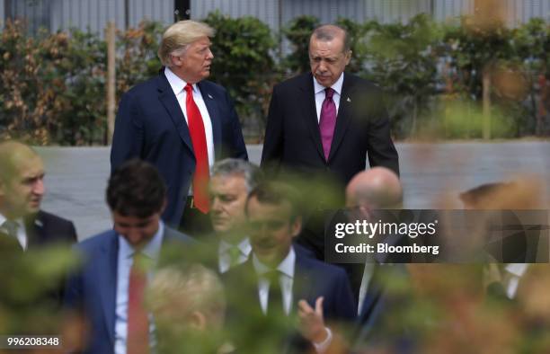 President Donald Trump, left, walks with Recep Tayyip Erdogan, Turkey's president, ahead of a family photo gathering at the North Atlantic Treaty...