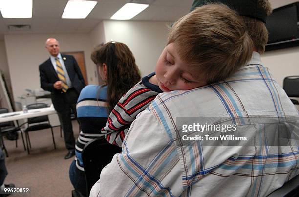 Leonard Rice holds his son Chance at a meeting with Rep. Steve Pearce, R-N.M., at Luna Community College in Santa Rosa, N.M.