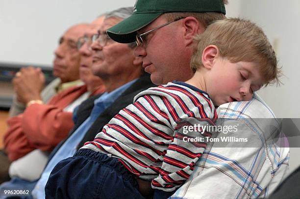 Leonard Rice holds his son Chance at a meeting with Rep. Steve Pearce, R-N.M., at Luna Community College in Santa Rosa, N.M.