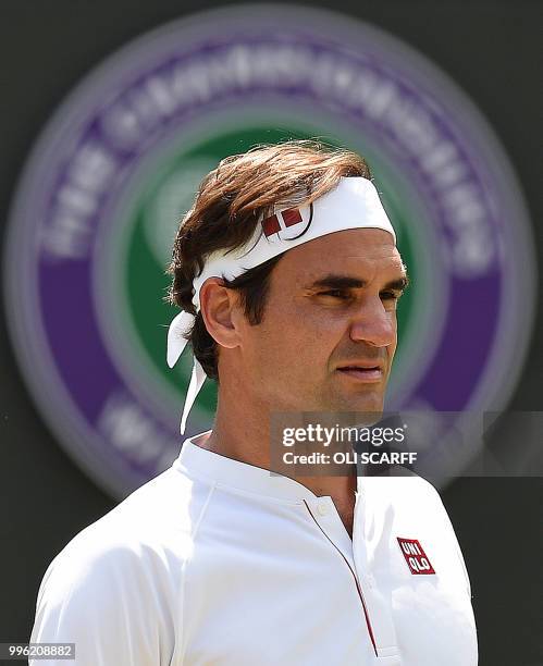 Switzerland's Roger Federer waits to receive a serve from South Africa's Kevin Anderson during their men's singles quarter-finals match on the ninth...