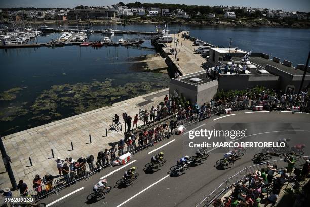 The pack rides along the harbour of Concarneau, western France, during the fifth stage of the 105th edition of the Tour de France cycling race...