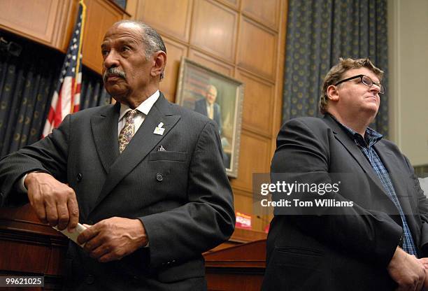 Filmmaker Michael Moore, right, and Chairman of the House Judiciary Committee John Conyers, D-Mich., attend a news conference with Chairman of the...