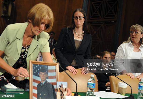 Larraine McGee sets out pictures of her son Staff Sgt. Christopher Everett, who was electrocuted while power-washing a Humvee in Iraq in 2005, as...