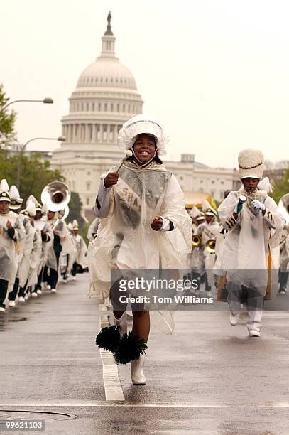 Melody Jackson a majorette from Shaw Junior High School marching band in NW, marches in rain gear during the Emancipation Day parade, Monday, on...
