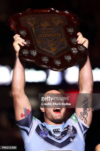 Boyd Cordner of the Blues celebrates with the shield after a series win after game three of the State of Origin series between the Queensland Maroons...
