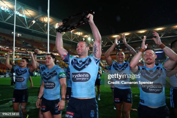 Boyd Cordner of the Blues presents the trophy to Blues fans after winning the series following game three of the State of Origin series between the...