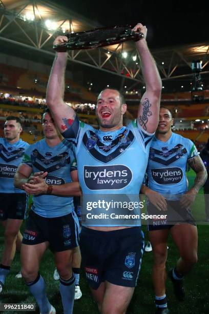 Boyd Cordner of the Blues presents the trophy to Blues fans after winning the series following game three of the State of Origin series between the...