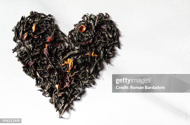the heart of the tea leaves on the white background - white tea stock pictures, royalty-free photos & images