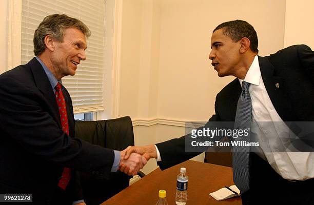 Sen. Tom Daschle, D-S.D., greets State Sen. Barack Obama, D-Ill., cbefore they call constituents in Illinois and ask for donations to the DSCC.