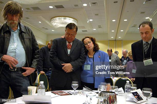 Fernando C de Baca and his wife Cecelia of Bernalillo County, pray during the benediction of the state republican convention at the Marriott hotel in...