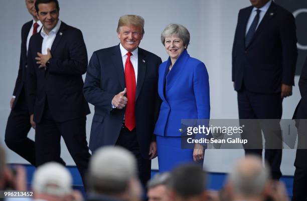 President Donald Trump and British Prime Minister Theresa May attend the opening ceremony at the 2018 NATO Summit at NATO headquarters on July 11,...
