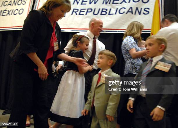 2nd District candidate Greg Sowards embraces his rand daughter Cindy while leaving the stage with his family after speaking at the state republican...