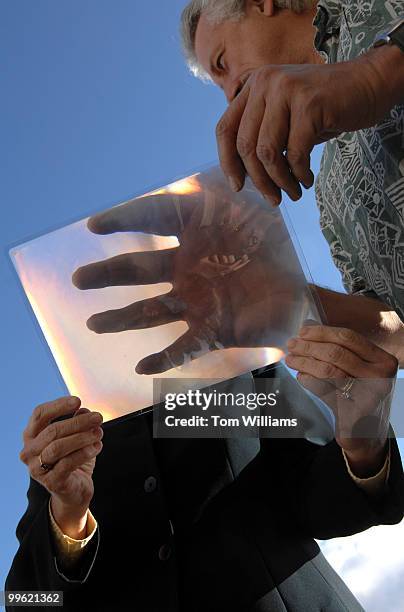 Rep. Heather Wilson, R-N.M., is shown a lens sunlight concentrating lens for a solar steam generator by Charles Shults at San Juan College in...