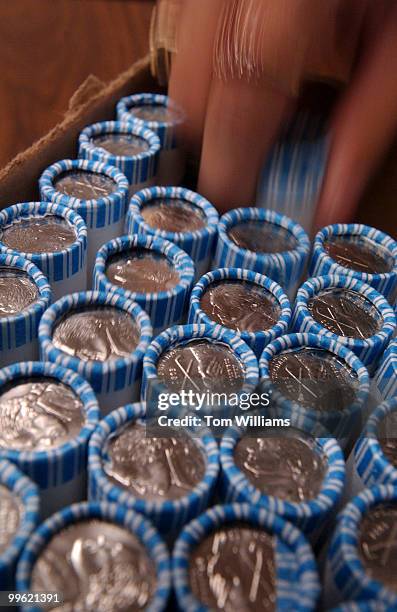 Sandy Marroquin of the U.S. Mint draws a roll of nickels that were distributed on the Hill to staffers and members, Wednesday. The coins are the...