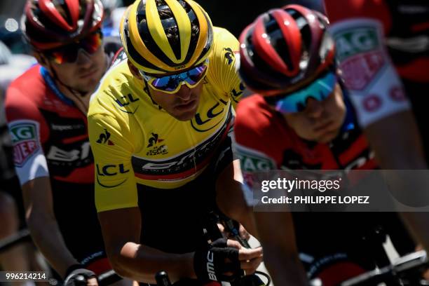 Belgium's Greg Van Avermaet, wearing the overall leader's yellow jersey, rides with his USA's BMC Racing cycling team teammates during the fifth...