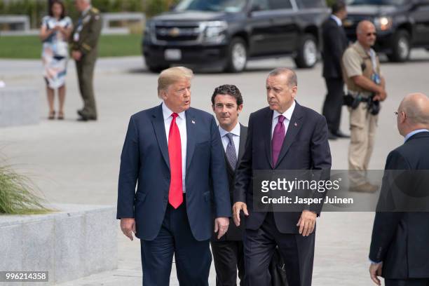 President Donald Trump walks with Turkish President Recep Tayyip Erdogan at the 2018 NATO Summit at NATO headquarters on July 11, 2018 in Brussels,...