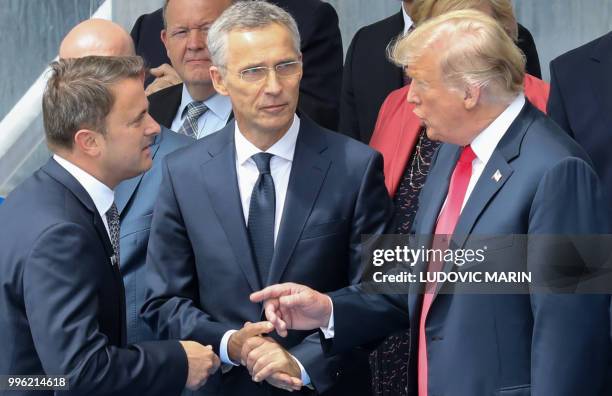 Greek Prime Minister's partner Betty Batziana, NATO Secretary General Jens Stoltenberg and US President Donald Trump talk during a family picture...