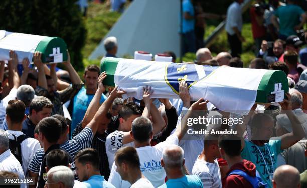 Relatives of Srebrenica victims carry the coffins of newly identified 35 victims while burial ceremony during the 23rd anniversary of the 1995...