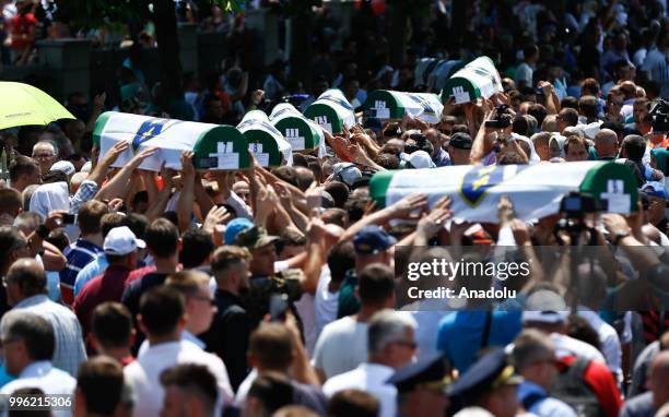 Relatives of Srebrenica victims carry the coffins of newly identified 35 victims while burial ceremony during the 23rd anniversary of the 1995...