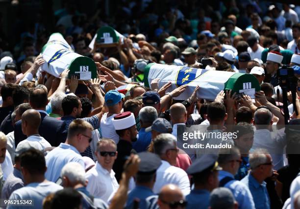 Relatives of Srebrenica victims carry the coffins of newly identified 35 victims while burial ceremony during the 23rd anniversary of the 1995...