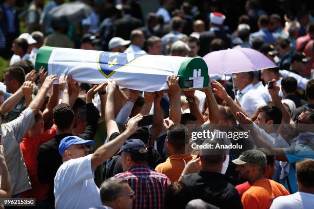 Relatives of Srebrenica victims carry a coffin of newly identified 35 victims while burial ceremony during the 23rd anniversary of the 1995...